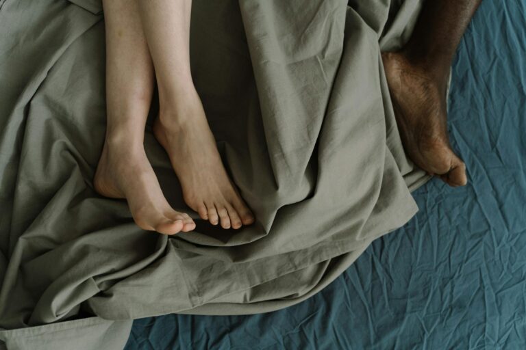 Barefoot Couple Lying in Bed